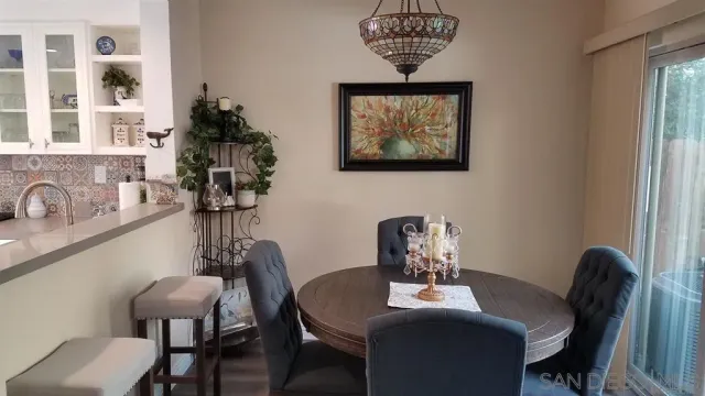 a view of a dining room with furniture and chandelier