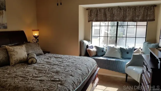 a bedroom with a bed and glass window