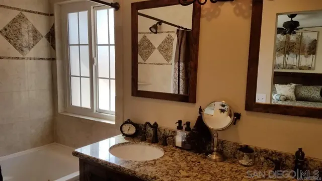 a bathroom with a sink toilet and a mirror