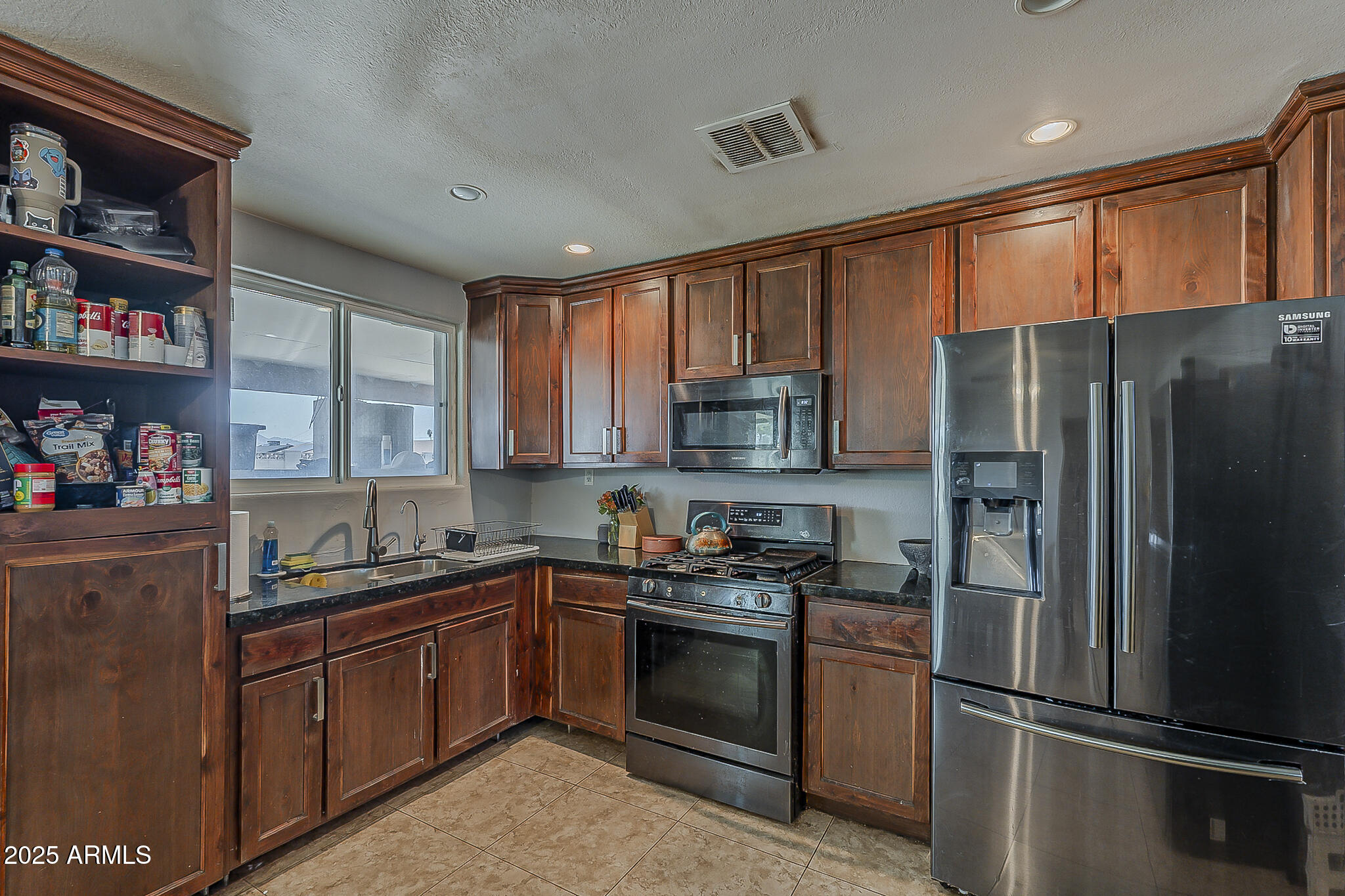 5319 West Osborn Road Phoenix, AZ 85031 - Photo 14 of 37 a kitchen with stainless steel appliances granite countertop a refrigerator stove and sink