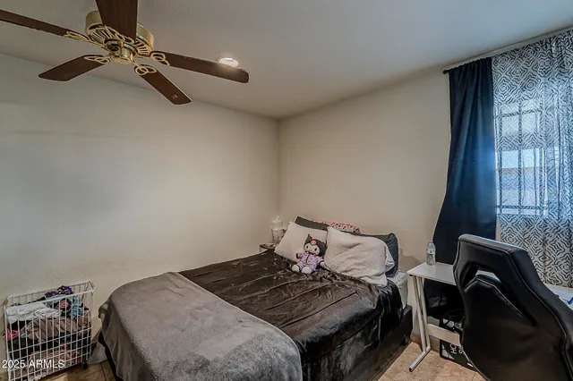 a bedroom with a bed and a window