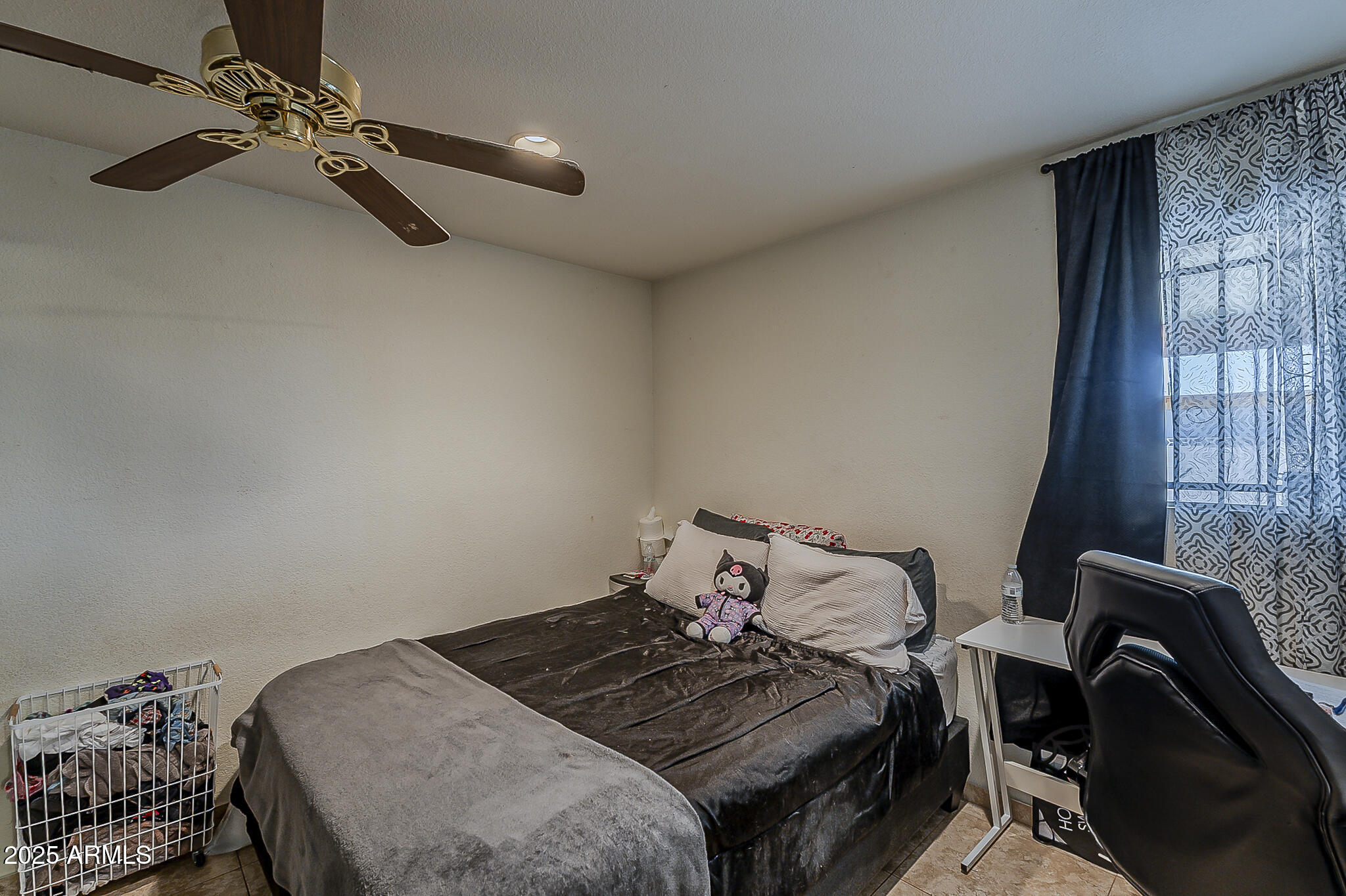 5319 West Osborn Road Phoenix, AZ 85031 - Photo 16 of 37 a bedroom with a bed and a window