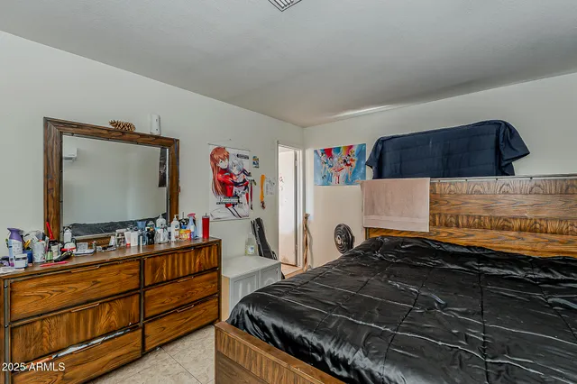 a bed room with a bed and a dresser