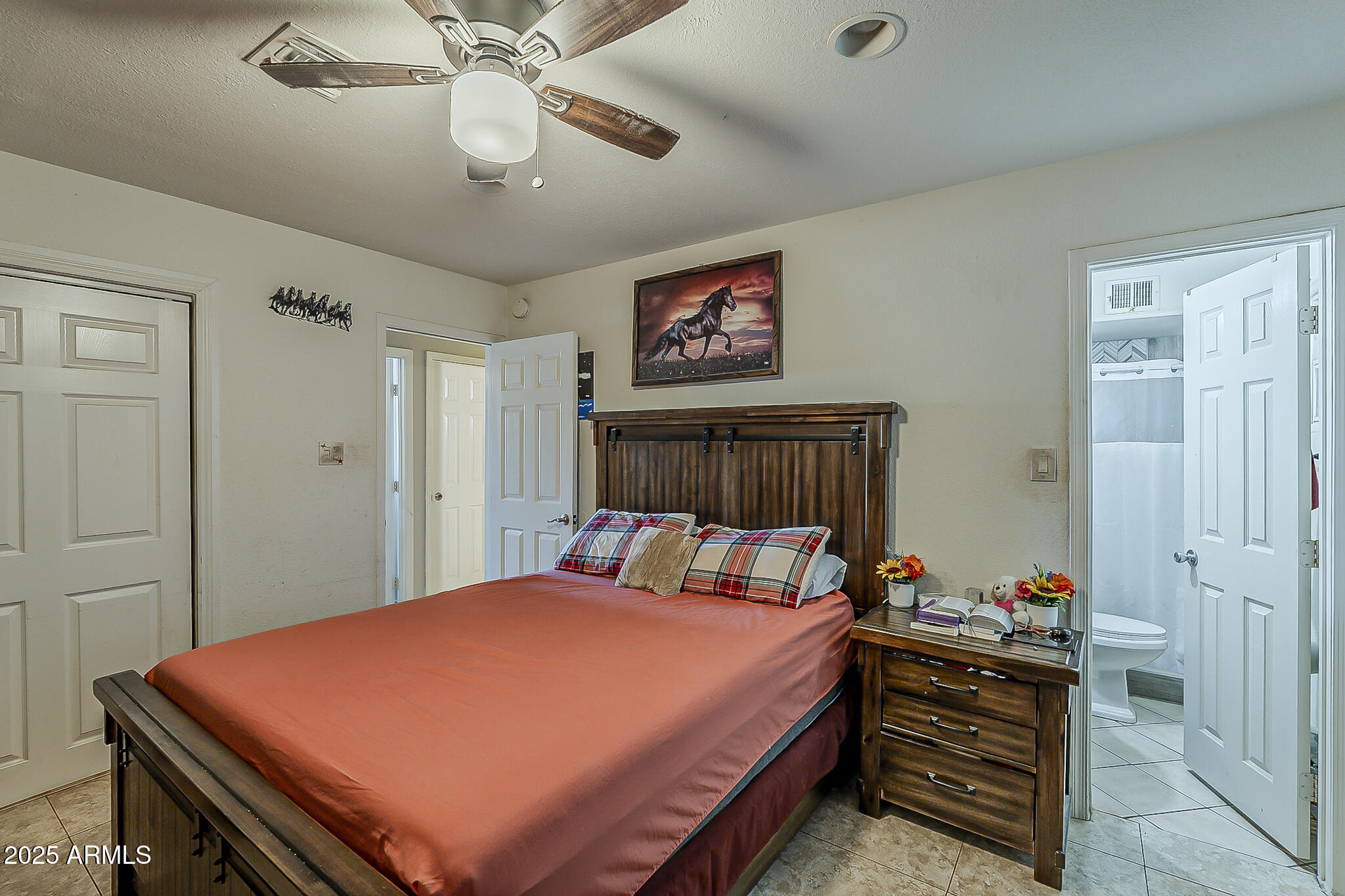 5319 West Osborn Road Phoenix, AZ 85031 - Photo 21 of 37 a bedroom with a bed and a chandelier