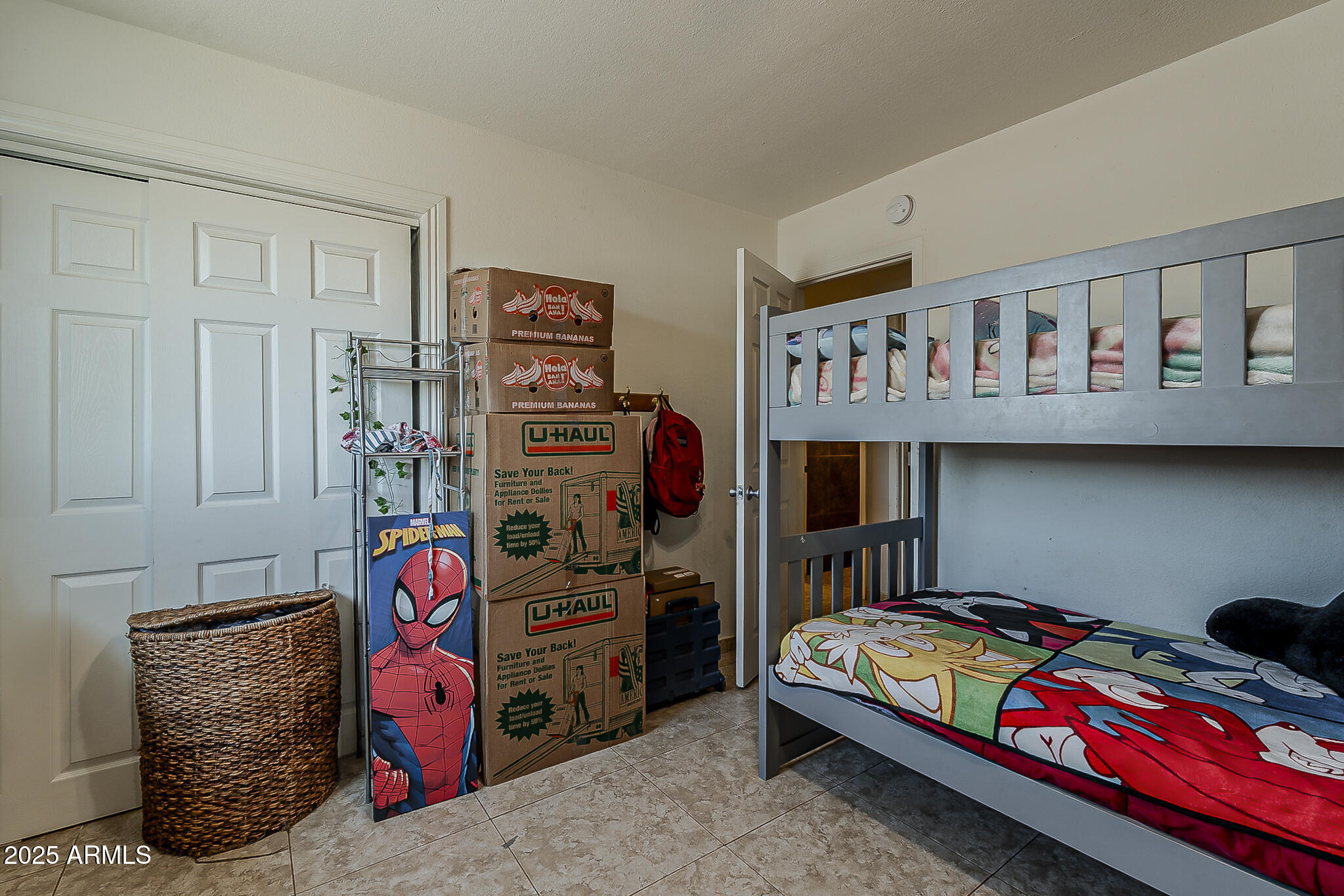 5319 West Osborn Road Phoenix, AZ 85031 - Photo 26 of 37 a bedroom with a bed and toys