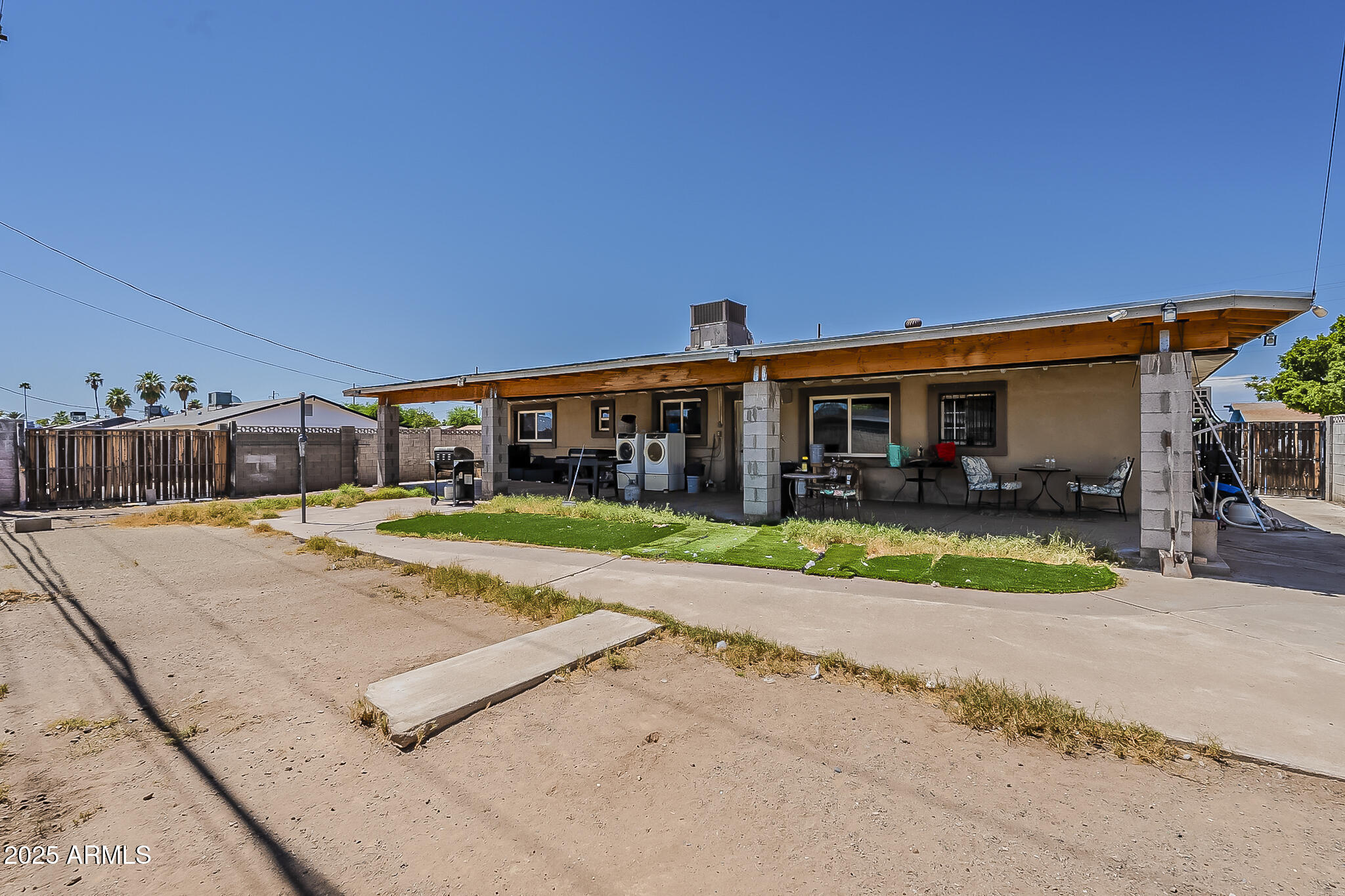 5319 West Osborn Road Phoenix, AZ 85031 - Photo 34 of 37 a view of an house with a swimming pool and a yard