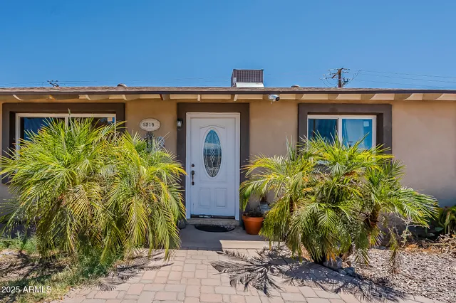 a view of front door and potted plants