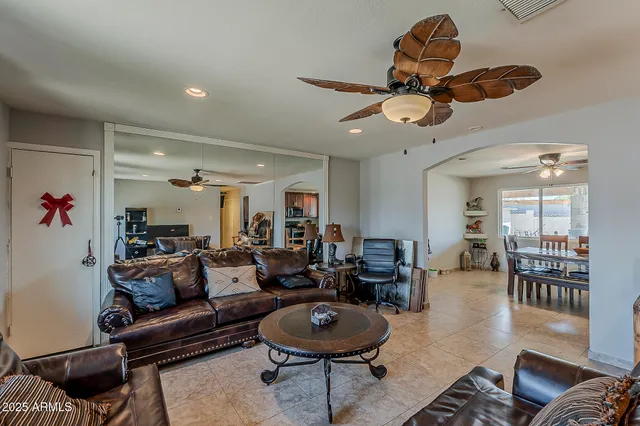 a living room with furniture a rug and a chandelier