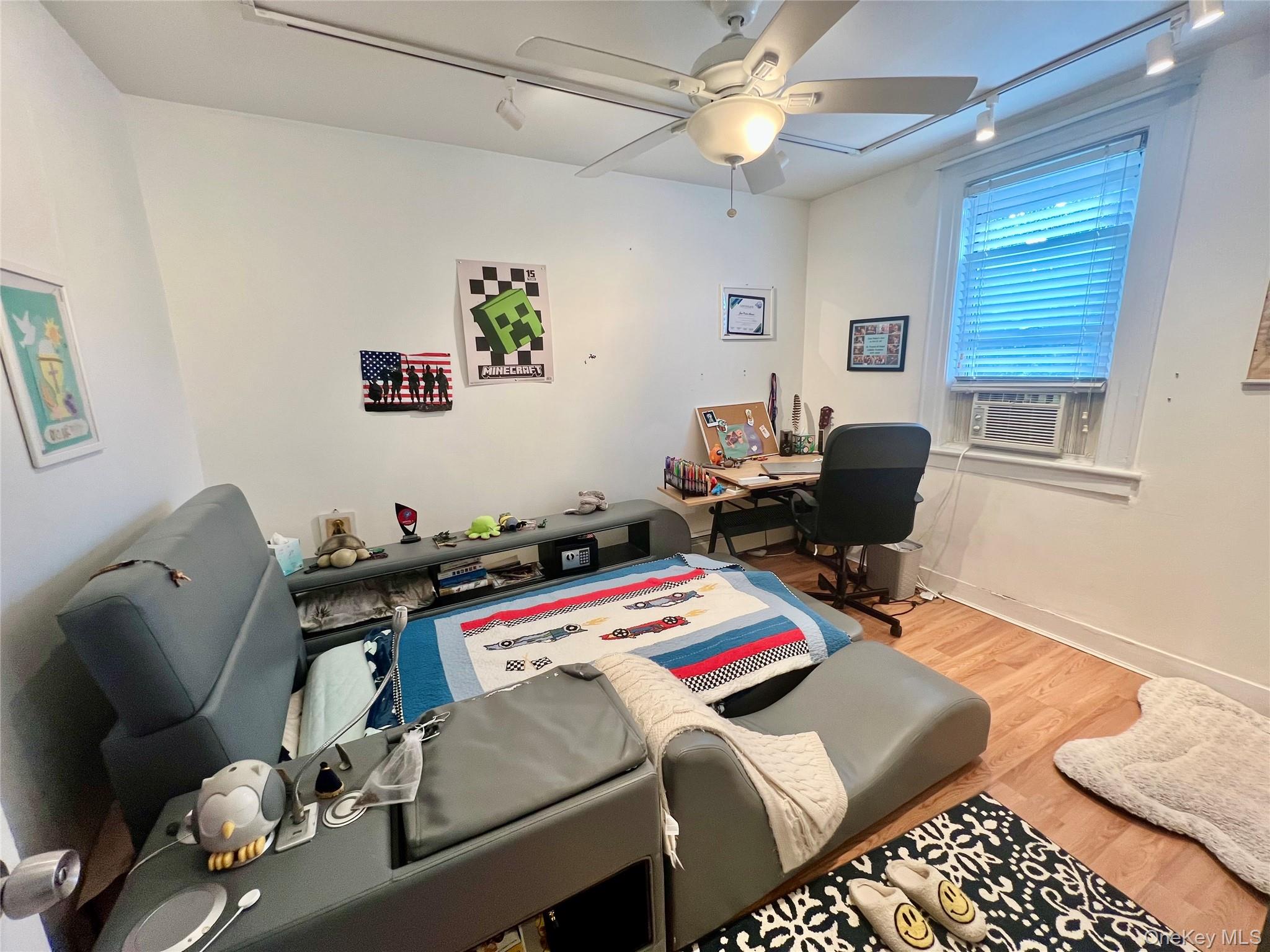 22-26 74th Street Queens, NY 11370 - Photo 11 of 19 a bedroom with furniture and a window