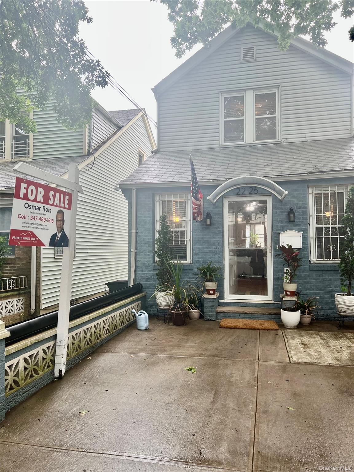22-26 74th Street Queens, NY 11370 - Photo 19 of 19 a front view of a house with parking area