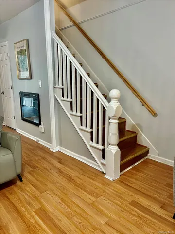 a view of entryway livingroom and hall with wooden floor