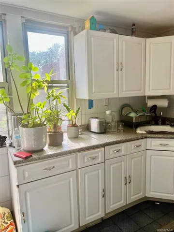 a kitchen with stainless steel appliances white cabinets and a granite counter tops