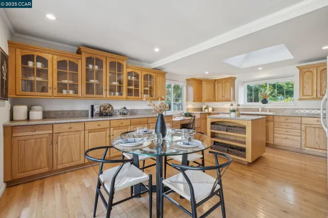 a dining room with furniture and wooden floor