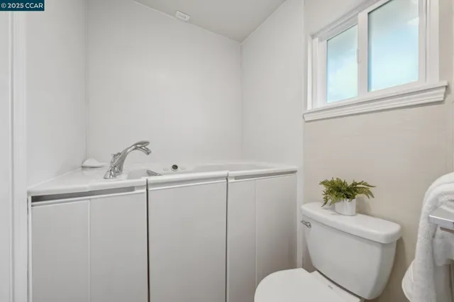 a bedroom with a bed and a potted plant