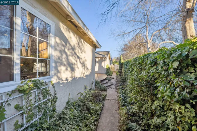 a view of a patio with table and chairs and potted plants