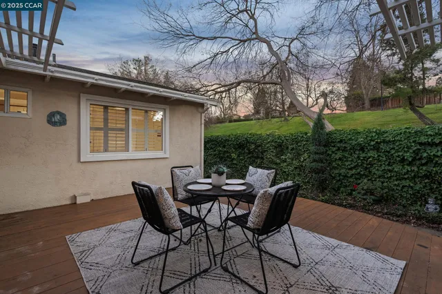 a living room with furniture a fireplace and wall paintings