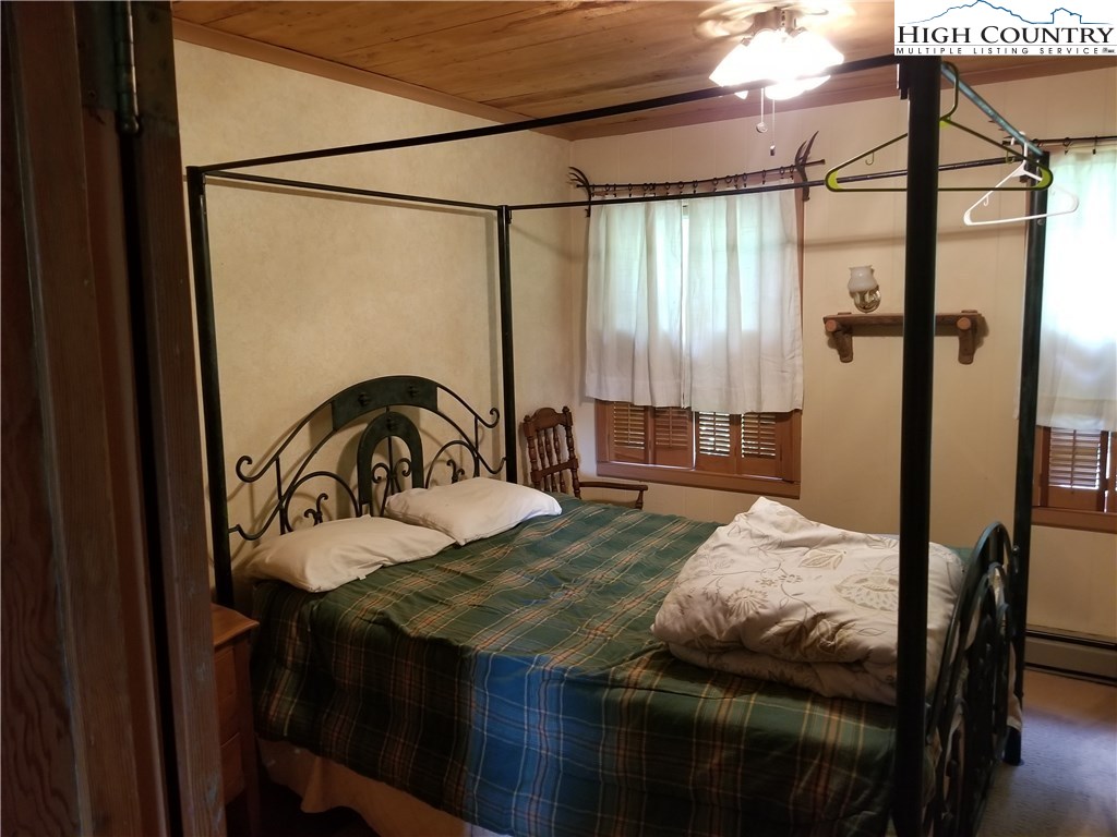1310 Dark Ridge Road Elk Park, NC 28622 - Photo 11 of 14 a bedroom with a bed and a table
