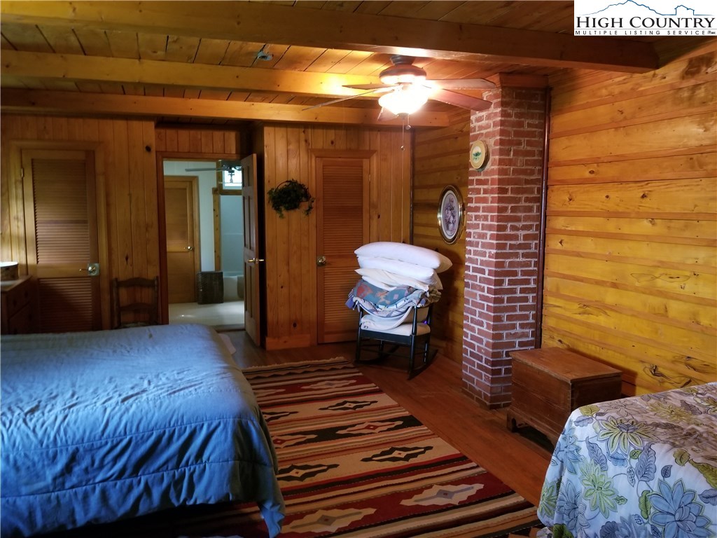 1310 Dark Ridge Road Elk Park, NC 28622 - Photo 13 of 14 a bedroom with a bed and wooden floor