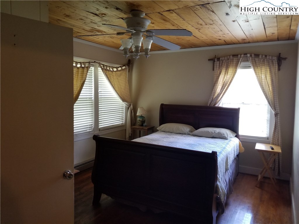 1310 Dark Ridge Road Elk Park, NC 28622 - Photo 8 of 14 a bedroom with a bed and a window