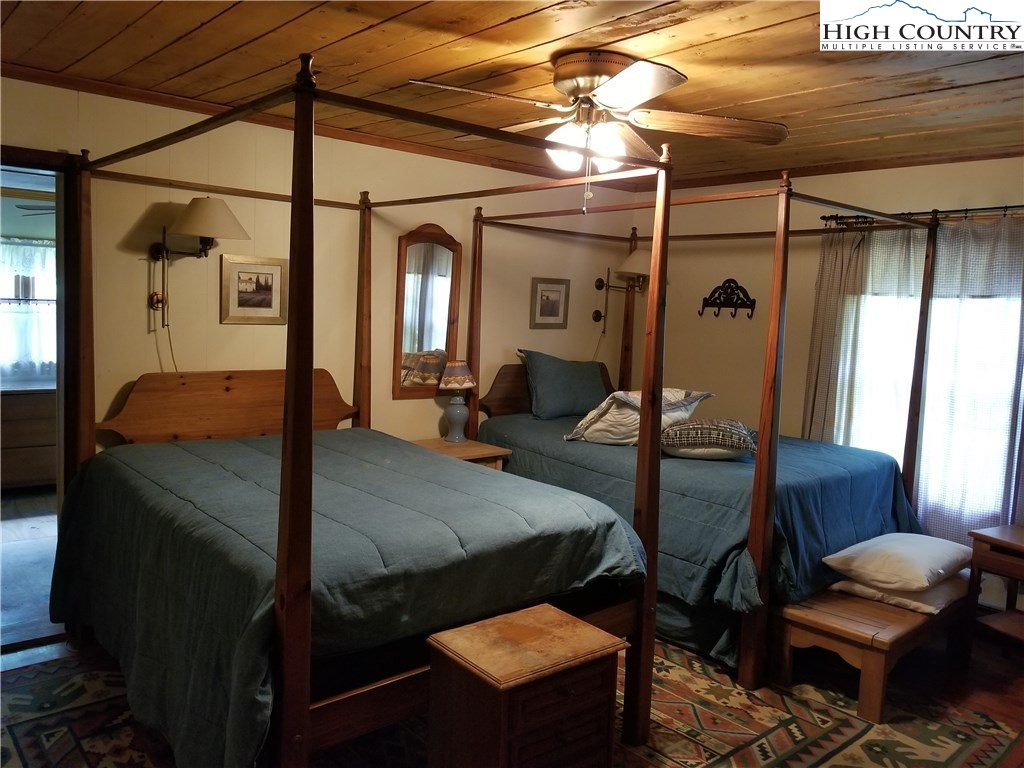 1310 Dark Ridge Road Elk Park, NC 28622 - Photo 9 of 14 a bedroom with bed and wooden floor