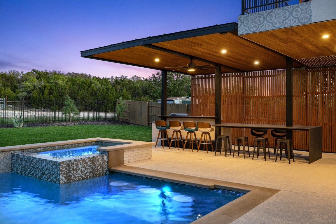 a view of swimming pool with outdoor seating and yard in the back
