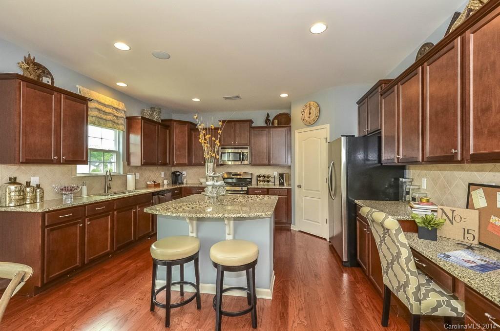 79184 Ridgehaven Road, Unit 295 Lancaster, SC 29720 - Photo 4 of 19 a kitchen with stainless steel appliances granite countertop a sink refrigerator and cabinets