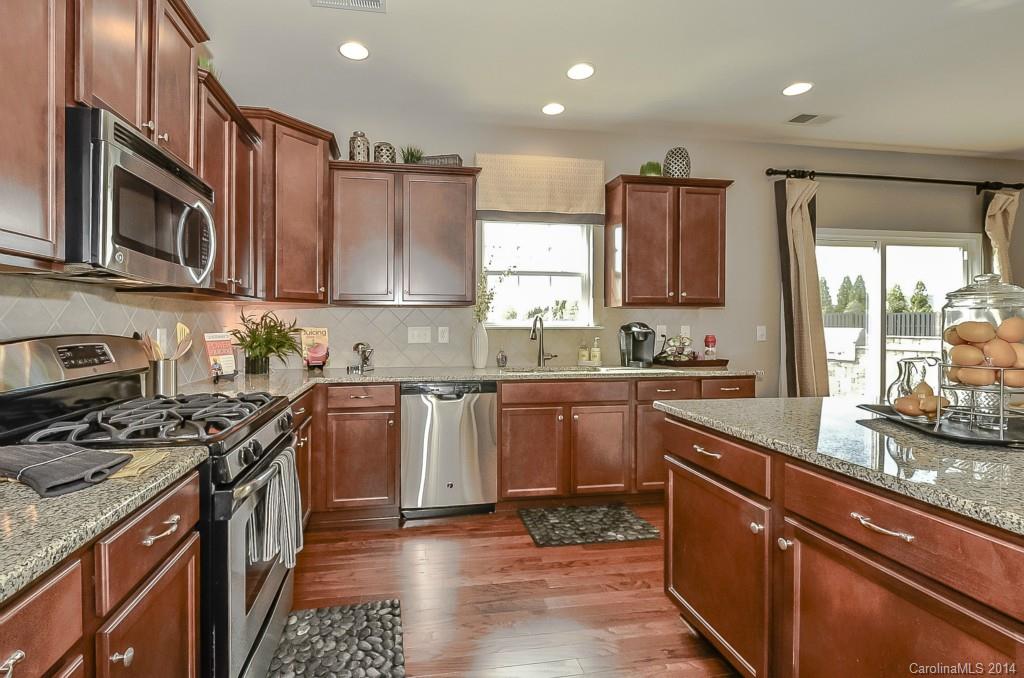 79184 Ridgehaven Road, Unit 295 Lancaster, SC 29720 - Photo 7 of 19 a kitchen with stainless steel appliances granite countertop a stove a sink dishwasher and a microwave