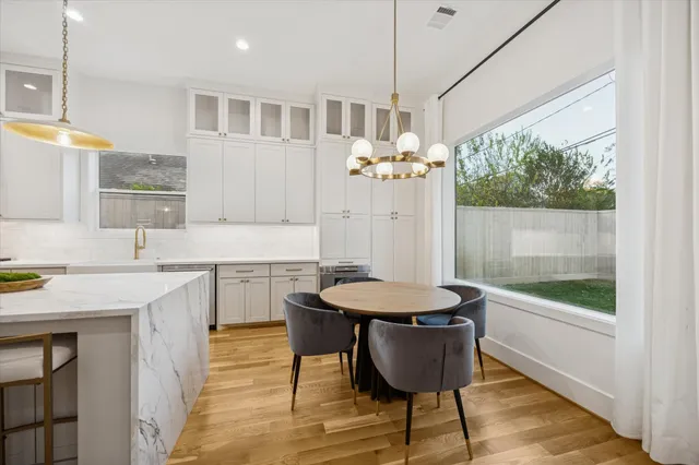 a bathroom with a granite countertop sink a mirror and a bathtub
