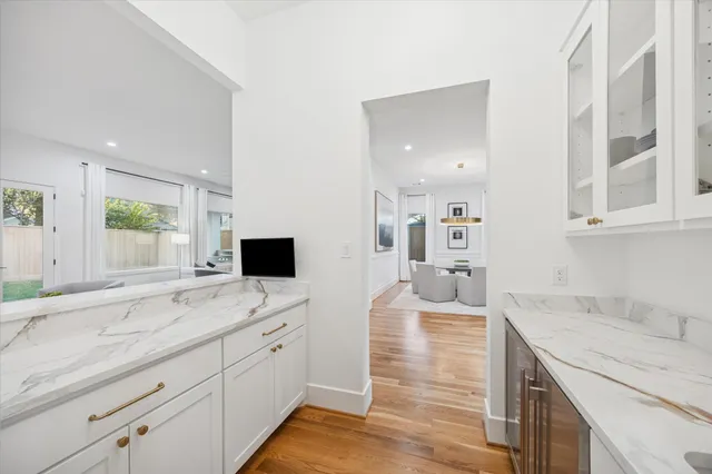 a spacious bathroom with a granite countertop sink mirror and bathtub