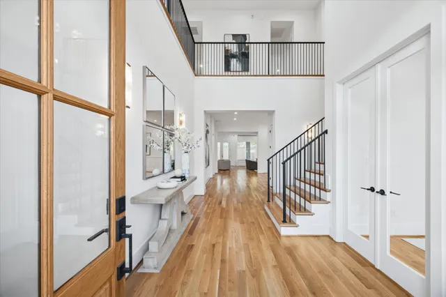 a view of a hallway with wooden floor and staircase