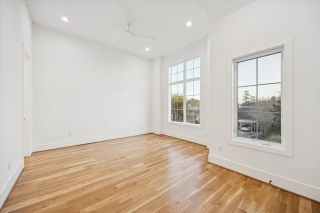 a bathroom with a bathtub shower sink mirror and toilet