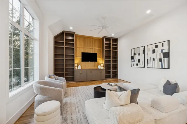 a living room with furniture windows and a flat screen tv