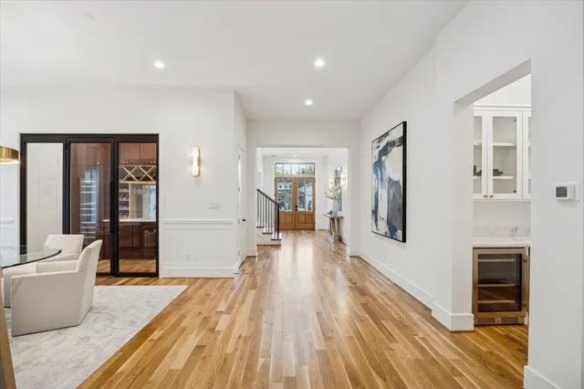 a hallway with wooden floor and windows