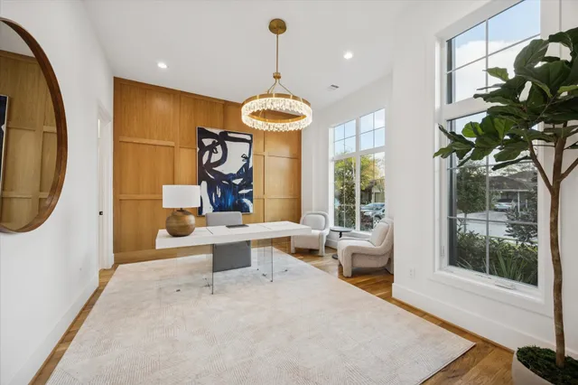 a living room with furniture a window and a chandelier