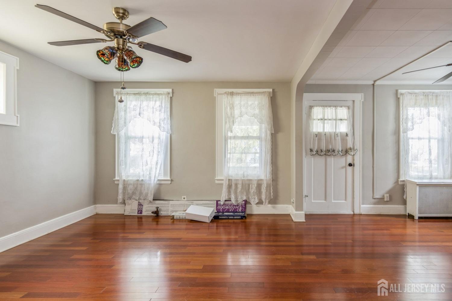 83 South Maple Avenue Springfield, NJ 07081 - Photo 11 of 38 a view of empty room with wooden floor and fan