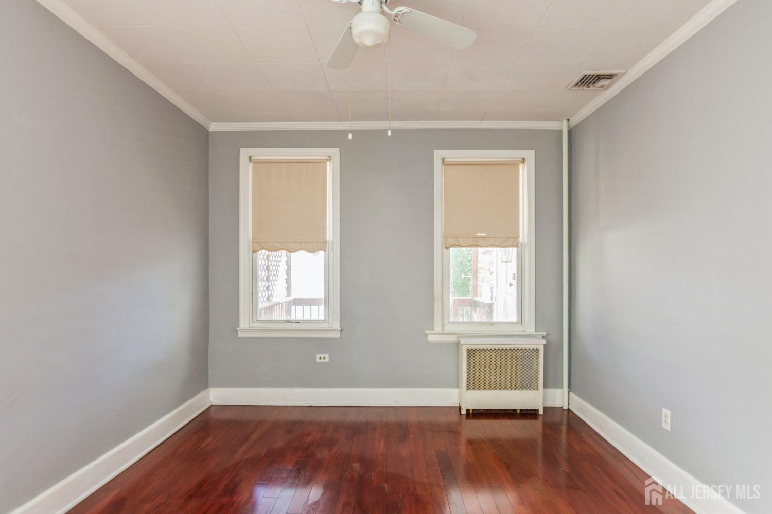 83 South Maple Avenue Springfield, NJ 07081 - Photo 12 of 38 an empty room with wooden floor and windows