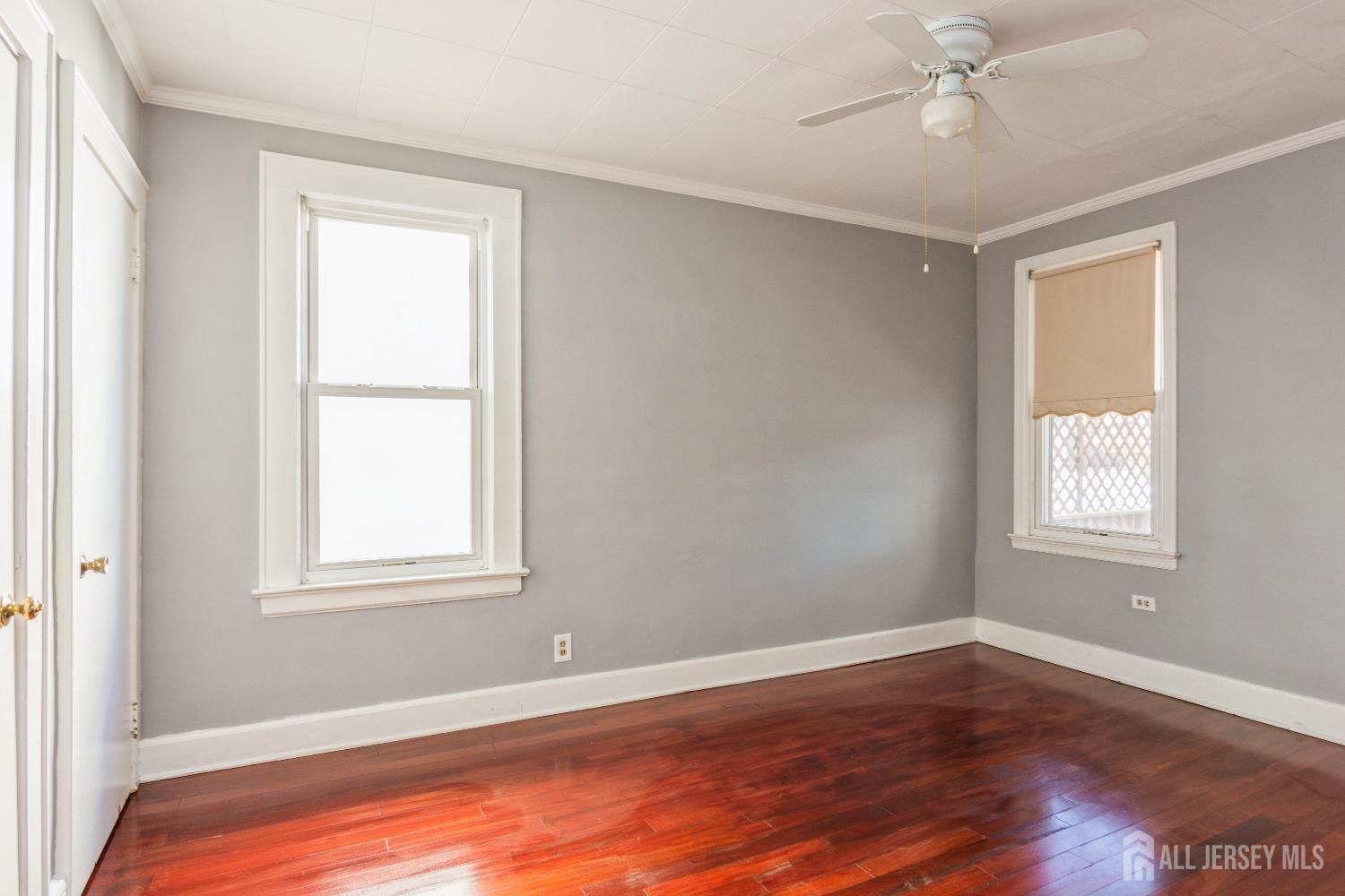 83 South Maple Avenue Springfield, NJ 07081 - Photo 13 of 38 a view of an empty room with wooden floor and a window