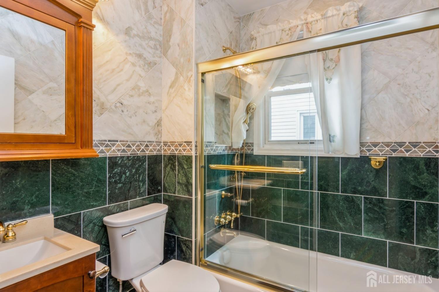 83 South Maple Avenue Springfield, NJ 07081 - Photo 14 of 38 a bathroom with a toilet a sink and a shower