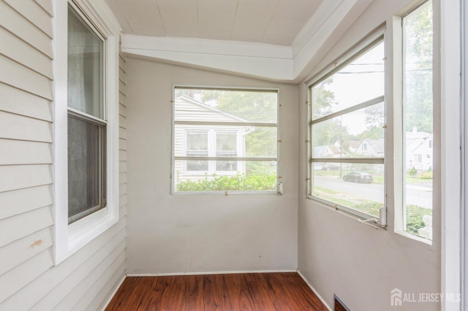 83 South Maple Avenue Springfield, NJ 07081 - Photo 2 of 38 a view of an empty room with wooden floor and a window