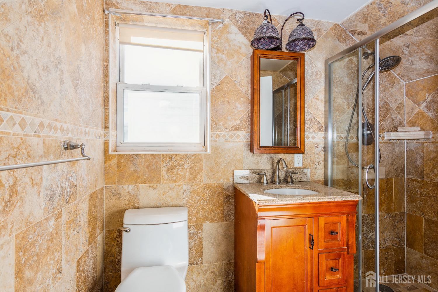 83 South Maple Avenue Springfield, NJ 07081 - Photo 21 of 38 a bathroom with a granite countertop sink toilet and shower