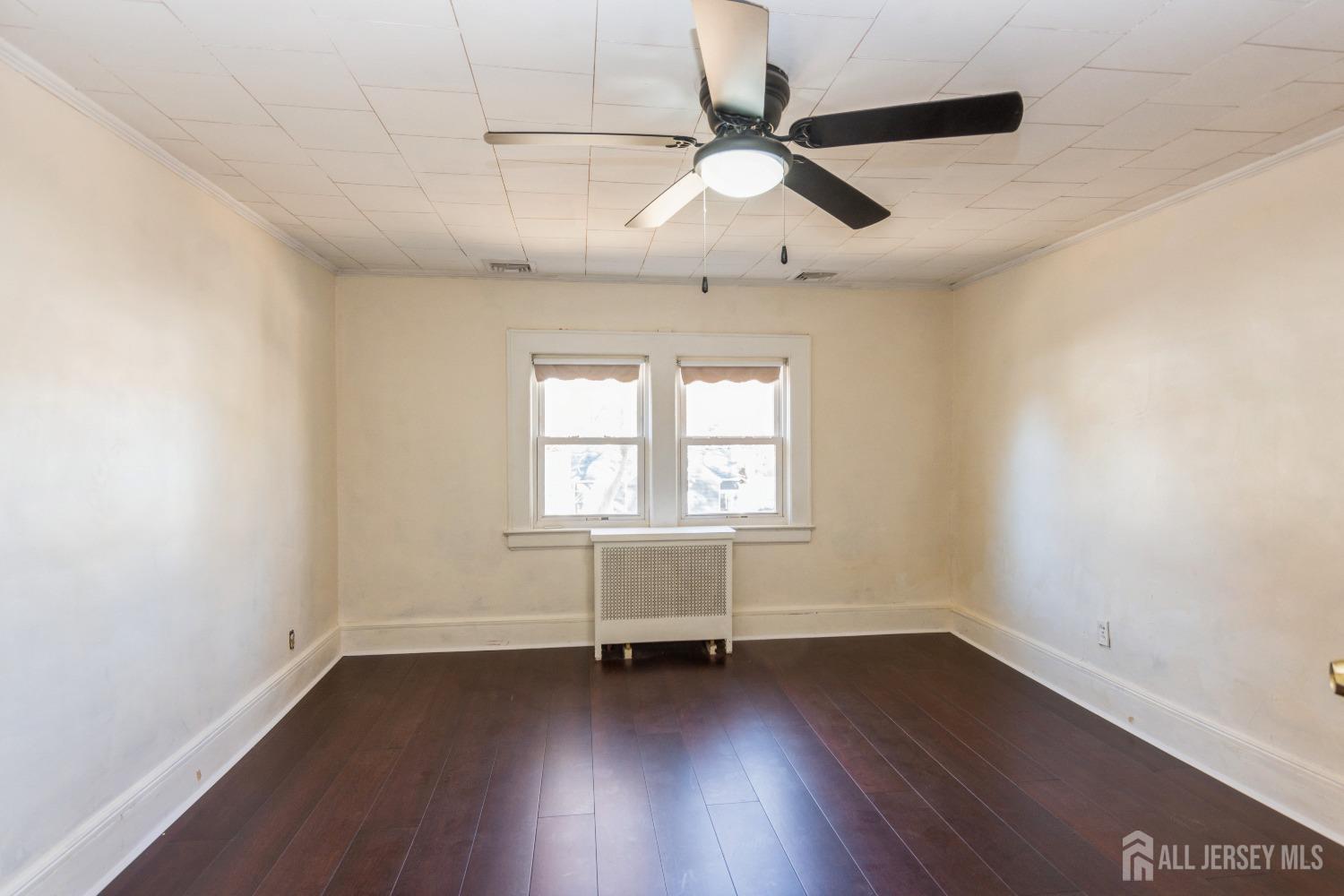 83 South Maple Avenue Springfield, NJ 07081 - Photo 24 of 38 an empty room with wooden floor and windows