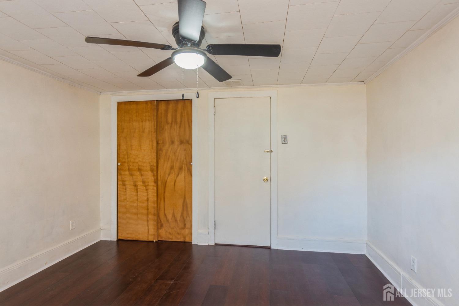 83 South Maple Avenue Springfield, NJ 07081 - Photo 25 of 38 an empty room with wooden floor fan and windows