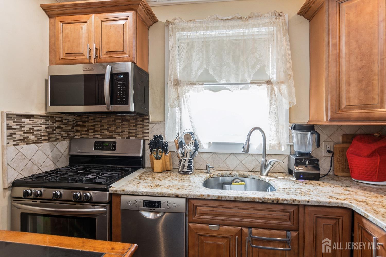 83 South Maple Avenue Springfield, NJ 07081 - Photo 8 of 38 a kitchen with granite countertop a stove a sink and a granite counter tops