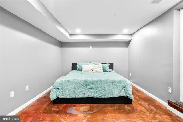 a bed sitting in a bedroom next to a window