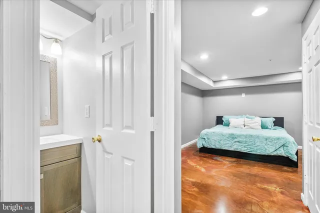a en suite bathroom with a granite countertop sink and a mirror