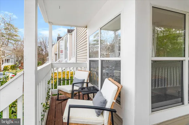 a view of a porch with furniture and a window