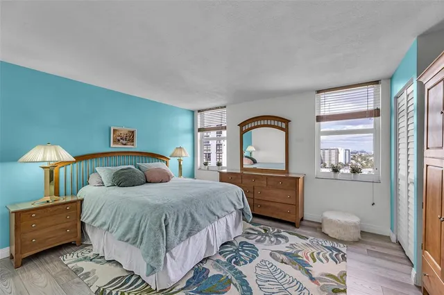 a bedroom with a bed and dresser with mirror