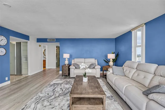 a living room with furniture and wooden floor
