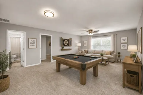 a room with furniture pool table and a window