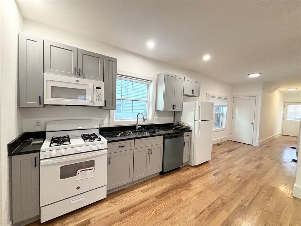 a kitchen with stainless steel appliances granite countertop a stove and a sink